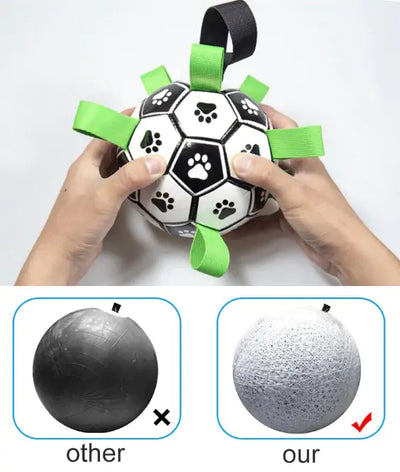 A person holds a black-and-white Gina’s Store Interactive Dog Toy Football with green straps and paw prints. Below, a comparison shows a plain black ball marked “other” and our durable gray ball with a red check for interactive play.